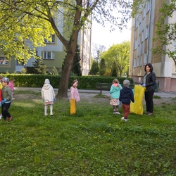 dzieci zbierają śmiecie na trawniku.jpg